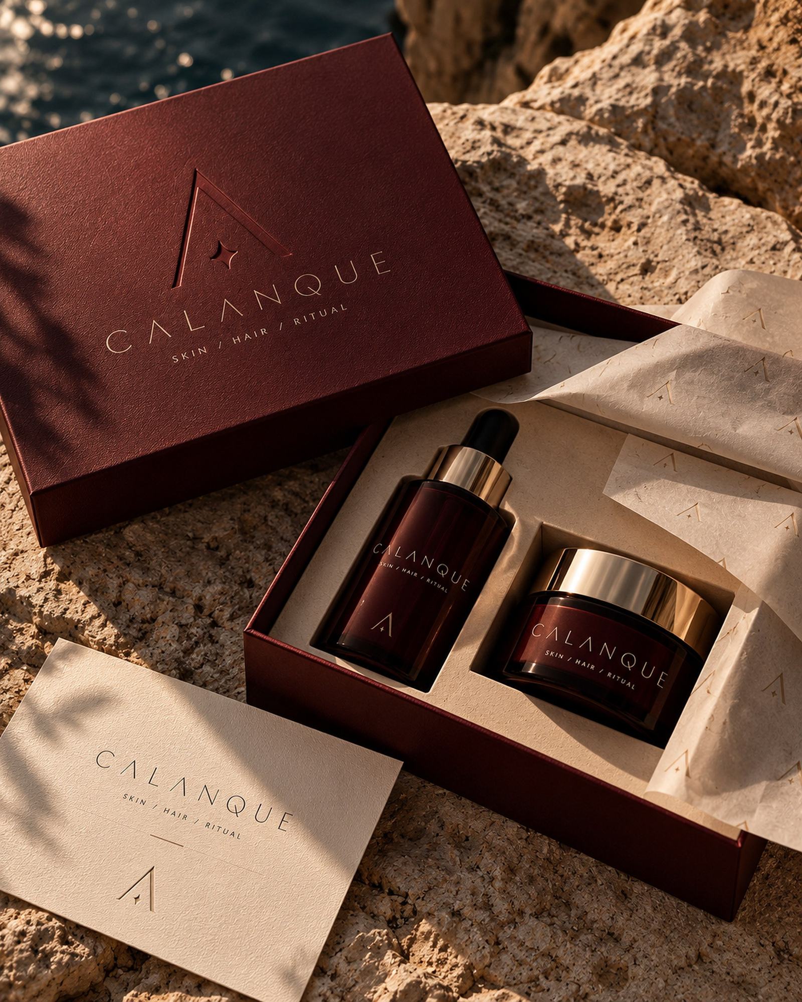 An open oxblood Calanque box holding the serum and cream